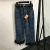 Pantalon d'épissage en plumes jeans pour femmes designer de créateur de denim pant