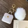 Porte-clés créatif en cuir PU Mini sac en peluche pompon porte-monnaie pochette mignon portefeuille femmes stockage petite boîte d'écouteurs porte-clés