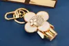 Luxur Designer Keychain Stylish Sun-Blomma Baby Image Pendant Keychains Trendy Keys Buckle Mens Womens Bag Ornaments High Quality