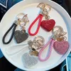 Keychains Lanyards Clay diamond full diamond love key chain studded leather rope cross-border heart-shaped car key chain female exquisite pendant. J240330