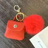 Porte-clés créatif en cuir PU Mini sac en peluche pompon porte-monnaie pochette mignon portefeuille femmes stockage petite boîte d'écouteurs porte-clés