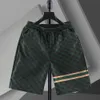 Shorts de seda gelada, marca moderna de verão masculino, calças casuais de praia de cinco peças para estudantes de secagem rápida, shorts finos de agasalhos