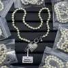 Miłosne pin Saturn Pearl Nonkacen łańcuch obojczyka Zachodnia Królowa planeta wisiorki Naszyjniki Dainty Chains Designer Jewelry N015