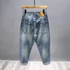 Streetwear rippade jeans för män Spring mode vintage byxor Lossa nödläge Motorcykelhålen denimbyxor 240325