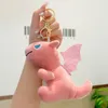 Llavero creativo de dinosaurio de peluche, muñeca bonita, colgante de muñeca, juguete de máquina de agarre, bolsa de libros, decoración colgante, pequeño regalo al por mayor