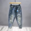 Streetwear rippade jeans för män Spring mode vintage byxor Lossa nödläge Motorcykelhålen denimbyxor 240325