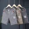 Heren shorts mode -label geborduurd vijf delige camouflage bedrukte casual broek, zomer snel drogende strandbroek