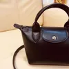 2024 Femmes nouveaux mignons en cuir exquis sac de boulet