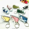 Mini -imitatie helder goud poeder canvas schoenen sleutelring hanger sportschoenen bagage auto hanger creatief cadeau