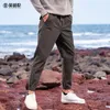 Pantalon masculin yingjuelun automne / hiver en peluche épaissie de couleur unie de couleur décontractée cordon de cordon