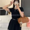 Womens two-piece set of sweet and elegant knitted sweater set skirt for early spring womens new age reducing short sleeved T-shirt with college style pleated skirt