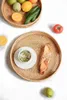 Theebladen handgeweven ronde rotan serveerlade met handgrepen Ottomaanse rieten schotel voor ontbijtdranken snack brood fruitgroenten