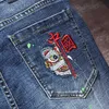 Jeans masculin pour hommes jeans chinois Style chinois brodé graffiti street trous hip-hop ultra-mince pantalon denim effilé