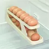 Almacenamiento de cocina plástico automático scrolling rejilla de huevo dedicada caja de tipo deslizante