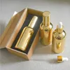 Speicherflaschen 4pcs 100 ml Hochtemperatur Gold plattierte Tropfenflasche mit Holzkasten leeres Glas ätherisches Öl Parfüm Unterpackung Jar