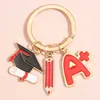 Keychains Lanyards Graduate Keynchain A + Crayon Capuladation Cape clé Anneau d'études Chaînes pour femmes Hommes sac à main Accessoires Accessoires DIY BIELLES CONDIONS Q240403