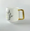 Elegante tazza di caffè in ceramica con manico dorato 240407