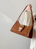 Schoudertassen 2024 Vintage niche dames onderarm mode suede high-end single vrouwelijke casual woon-werkverkeer bruin handtas