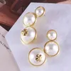 Boucles d'oreilles étalons bijoux de marque de tendance européenne et américaine en gros en gros boucles d'oreilles en orage en forme de trèfle à quatre feuilles.