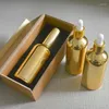 Garrafas de armazenamento 4pcs 100ml de alta temperatura Garraco de gotas de ouro com caixa de madeira Vidro vazio de óleo essencial de perfume Subpackage Jar