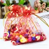 ギフトラップ100pcs/lot bronzing Heart Pattern Organza Bags Jewelry Packaging Drawstring Yarnネットウェディングパーティーポーチ