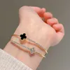 Feerie Van Armband Schatzschmuck Doppelschicht Blume vier Blattgrasarmband Elegante Stil 14K Gold plattiert schwarze Frau