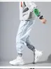 Jeans masculin coréenne de mode coréenne en denim bandes pantalon de cargaison gris noir pour streetwear harem en baggy élastique hip hop