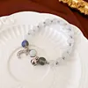 Diamond Moon Bell's Cat's Eye Stone Breded Bracelet avec petit et frais de design de mode, de nouveaux bijoux artisanaux polyvalents pour les femmes