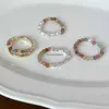 Un diseño de nicho con un anillo de decoración de esmalte de perla de alta gama para el anillo de dedo del dedo de la cuerda elástica versátil con cuentas de moda para mujer