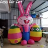 8 mh (26 stóp) z Blower Airbllown Easter Cartoon Rabbit Różowy nadmuchiwany królik w Rompers z dwoma jajkami wielkanocnymi do festiwalowej dekoracji stoczni na świeżym powietrzu