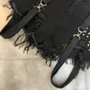 Letni pasek na ramię kobiety Kobiety dżinsowe szorty damskie damskie black hole Tassel Streetwear Sexy kombinezon Jean 240411