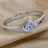 Bracelet des yeux bleus rotatifs en acier inoxydable avec accessoires de strass de luxe pour femmes coiffures bijoux imperméables