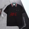 24SS Men T Shirt Diseñadores de polo Carta G Camisas de moda Mujer Camas de manga corta Bests Blancos Blancos Venta Venta de chándal para hombres Tops casuales al por mayor 258