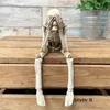 1pc Skull Statues Set Resin Skeleton Shelf-Sitters Assis Figurines pour la librairie à domicile Coule Decorative 240409