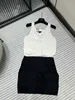 Basic & Casual Dresses designer A must-have item for this season, black and white color block, drum dot hollowed out knitted vest skirt, embellishment at the neckline 4IF4