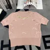 Designer de t-shirts pour femmes Xiaoxiangfeng 24 Été Nouvelle industrie lourde à cou rond chaîne tricotée diamant plein arc Pullover à manches courtes