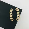 Bloccia da donna maschile marchio di design alfabeto alfabeto classico smalto in bianco e nero smalcio lussuoso gioielli ottoni di brass