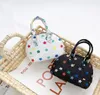 Kinder Handtaschen Koreanische Mode kleine Mädchen Prinzessin Geldbörsen Geschenke Kleinkind Baby Mini Messenger Bags Klassische Druck PU Lederschalen Umhängetasche 5724047