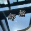 Luo Familys French style full diamond earrings are meticulously carved with heavy craftsmanship and the highendf eelingi si nlaidw ithd iamondsTh ege ometricho llo