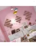Płytki dekoracyjne Salon paznokci umieszcza półkę w kształcie diamentu w szafce na ścianę