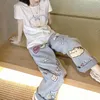 Jeans pour femmes de style japonais caricaturé printanière de pâte animale en tissu de pâte de pâte de pâte doux mignonnes mignonnes et droite pour les femmes