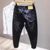 Vita jeans män all-match mode rippade hål smala stretch harem byxor bekväma manliga streetwear denim byxor 240412