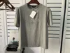 Homme de chemise de chemise Tshirt Designer femme avec des boutons en argent