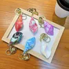 Keychains Lanyards 1pc Söt conch Keychain Creative Colorful School Bag ryggsäck Pendant Cartoon Utsökt bil nyckel Tillbehör Nyckelring för kvinnor