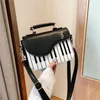 Tas 2024 Koreaanse piano design damesschouder pu lederen messenger handtas mode strakke make -up pocket munt portemonnee