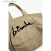 Bolsa de fraldas Carta Bolsa de zíper bordada Mulheres de grande capacidade Tote casual Bag unissex Luxo Design de compras leves para mulheres L410