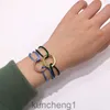 Trinity Bracelet Baojia同じ新製品レッドロープカップルブレスレットゴールドサークルDIYハンドロープチタンスチールブレスレット