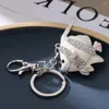 Keychains 2024 Spring Fashion Cute Metal Imitation Platinum Painting Oil Chubby Fish Bag Wallet Keychain Birthday Party Gift