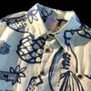 Camisas casuales para hombres Camisa floral de graffiti hawaiano camisas de cuello cubano de estilo Hong Kong de verano para hombres y mujeres 24416