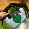 För ny dekoration handväska bulle söt graffiti hög designer väskor kvinnor 2024 klass kort handtag drake mångsidig axel dumpling crossbody womens väska 6u7i